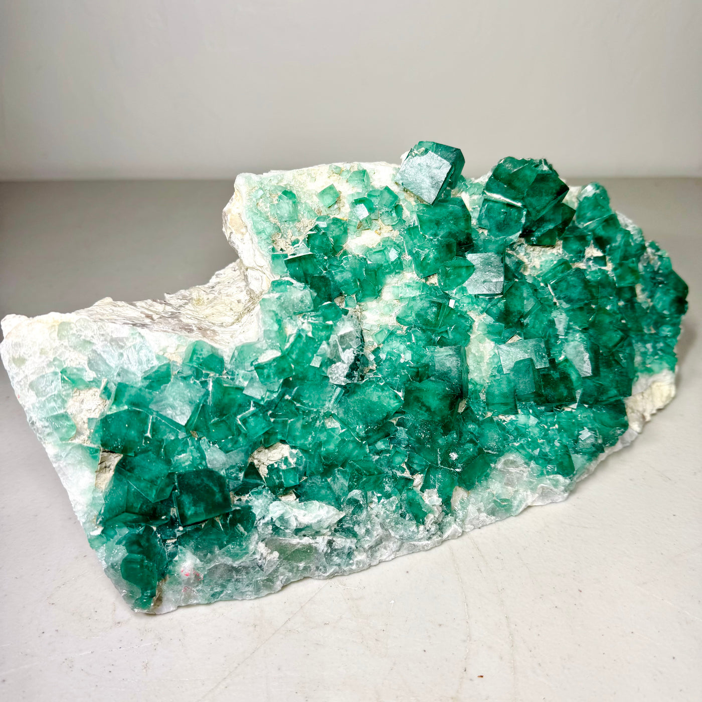 Green fluorite cubic cluster on pale matrix, front view