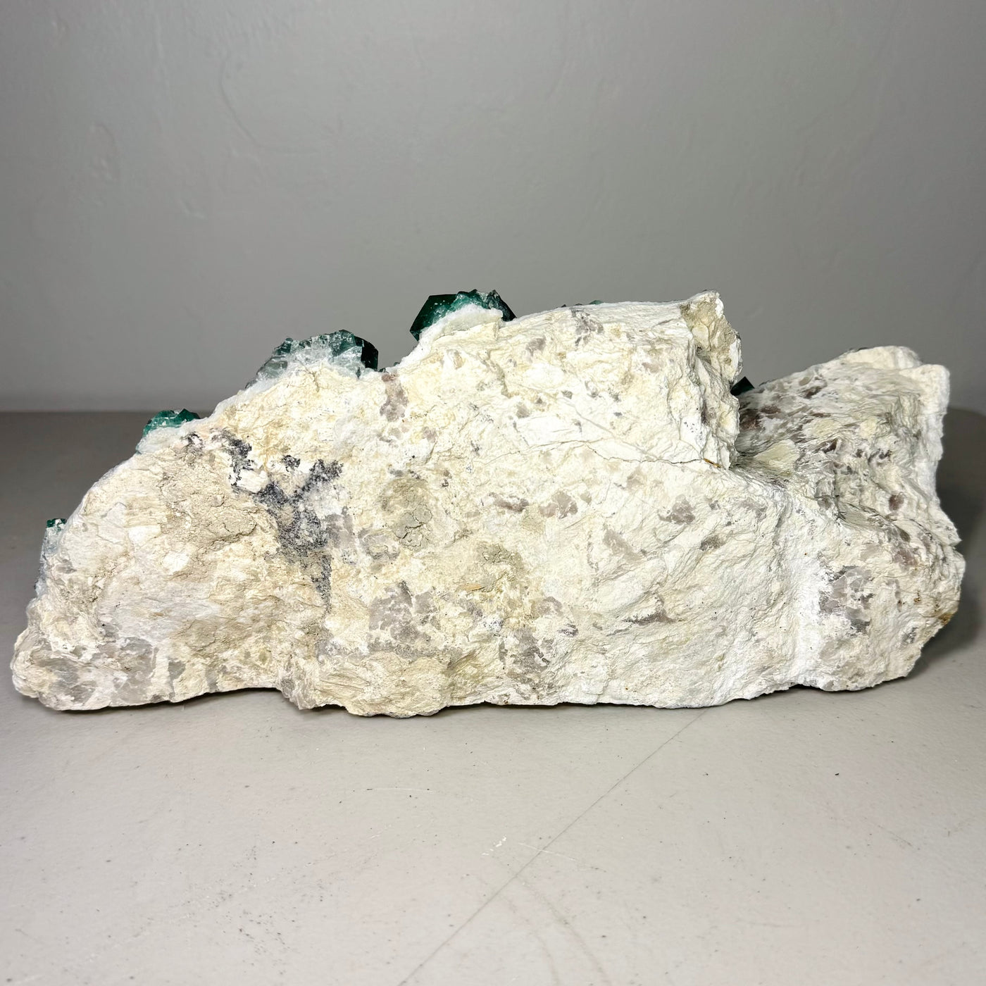 Green fluorite cluster showing translucent cubic crystal faces