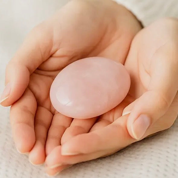 Natural pink rose quartz palm stones showing varied shape and pattern