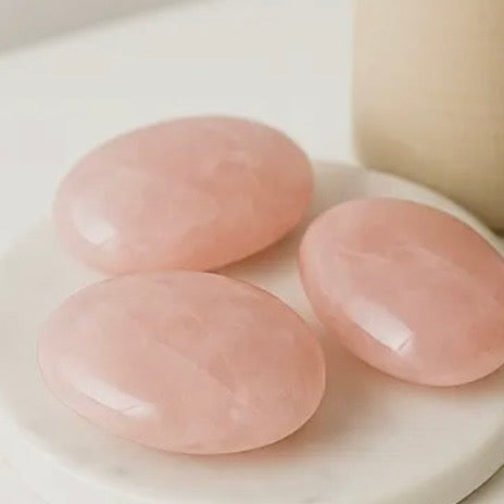 Polished rose quartz palm stones prepared for resale, gifting, or display