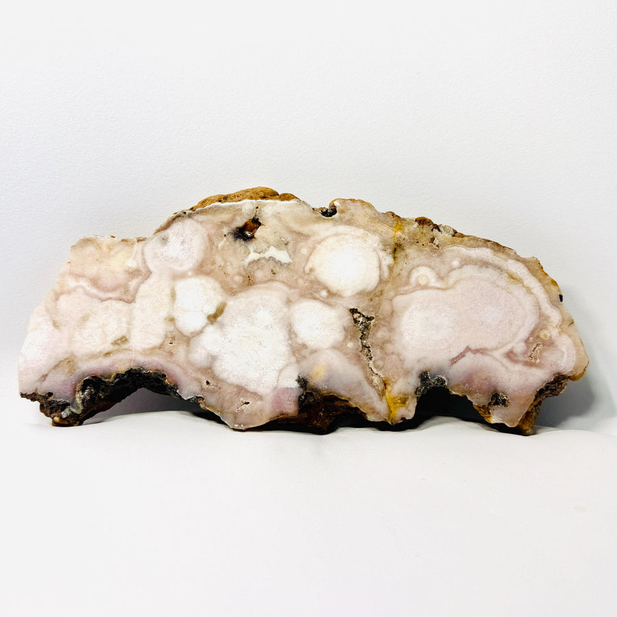 Long natural agate slab with off-white orbicular formations and earth-tone rough edges