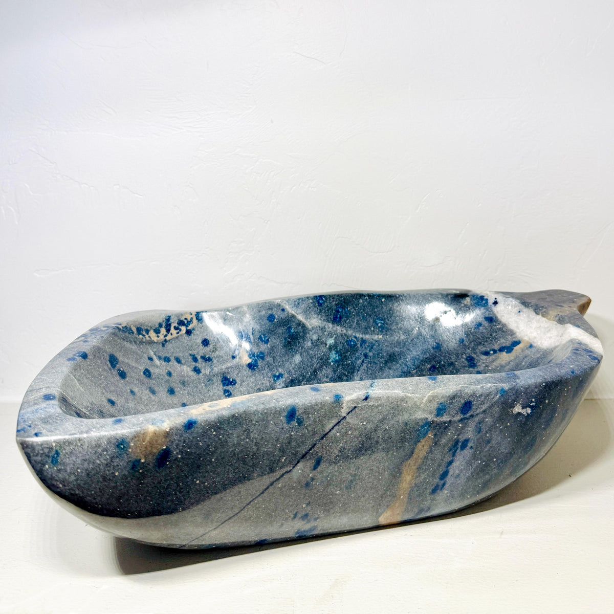 Alternate view of quartzite bowl AE110 showing elongated rim and blue spotted interior