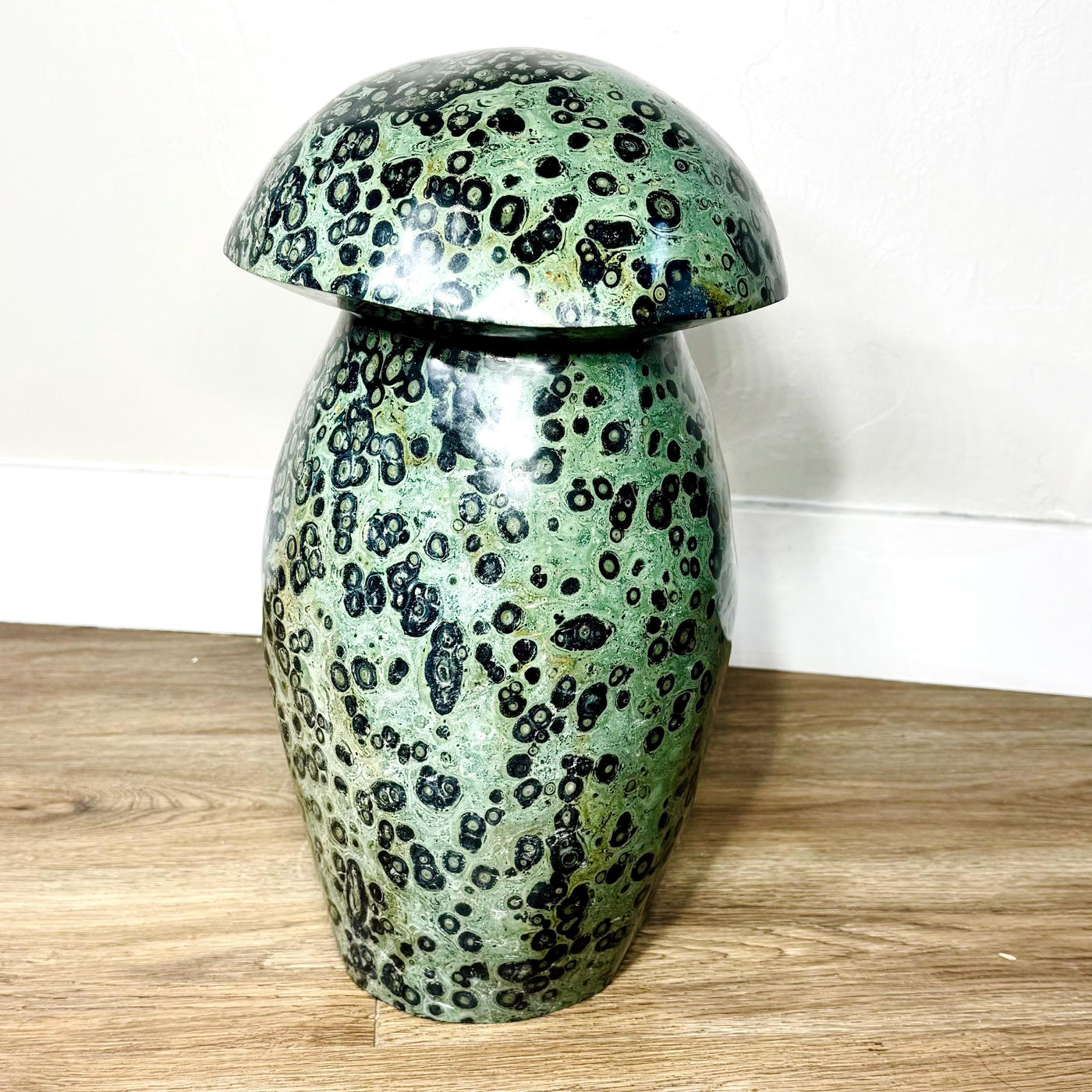 Alternate side of the Kabamba Jasper mushroom showing pale green areas and dark circular patterns