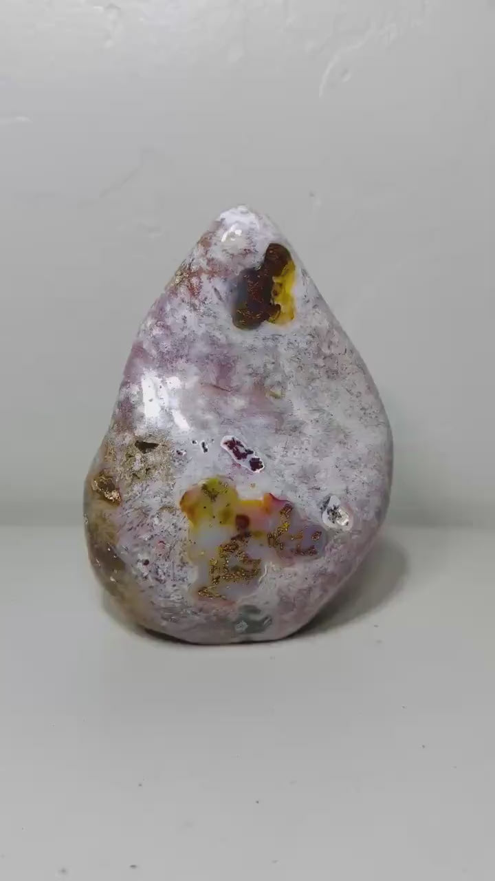 Video of one-of-a-kind pink amethyst freeform ML-166 rotating to show its lavender color and amber inclusions