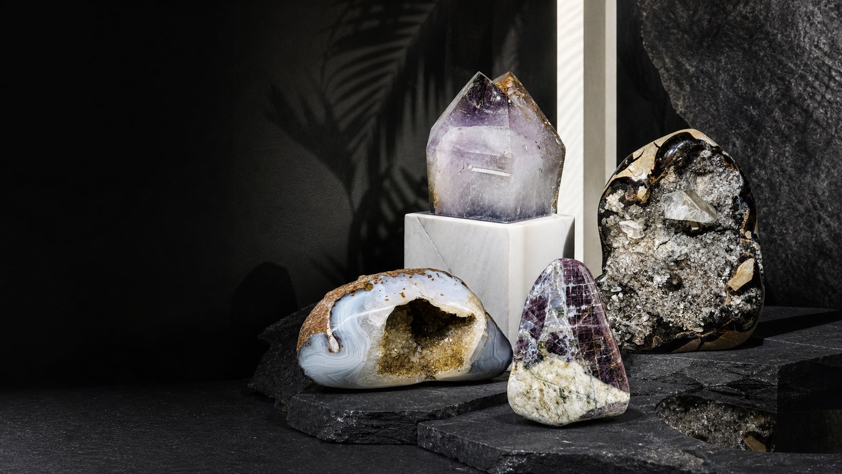 Fine agate, amethyst, septarian, and purple anhydrite specimens displayed in a collector gallery